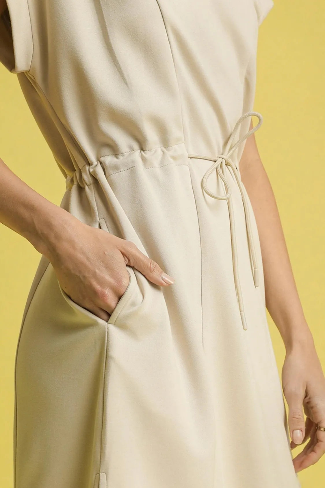 This versatile midi tee dress features a relaxed, comfortable fit perfect for everyday casual wear. Crafted from soft cotton blend fabric in a neutral beige tone, it offers effortless style with its crew neckline and short sleeves.