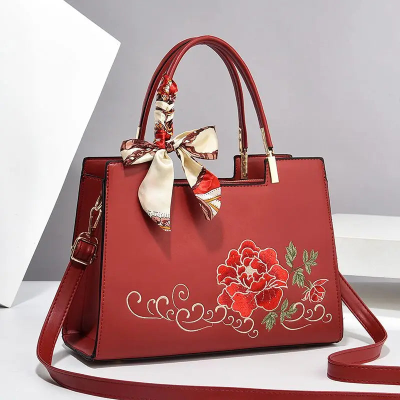 Vegan leather medium size handbag with floral embroidery