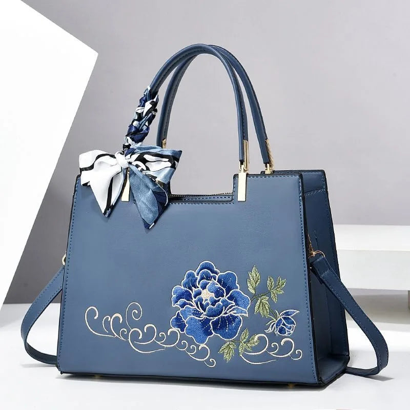 Vegan leather medium size handbag with floral embroidery