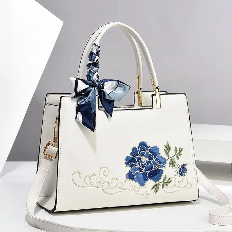 Vegan leather medium size handbag with floral embroidery