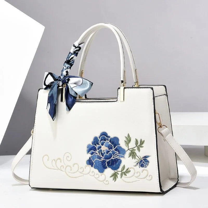 Vegan leather medium size handbag with floral embroidery