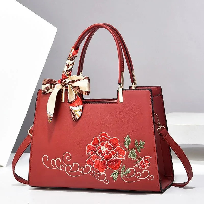 Vegan leather medium size handbag with floral embroidery