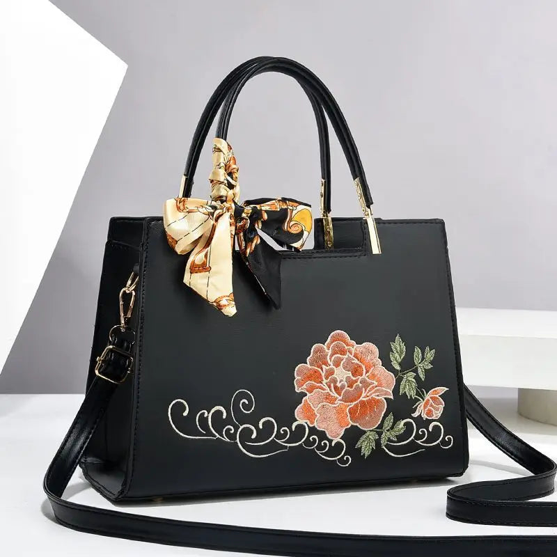 Vegan leather medium size handbag with floral embroidery