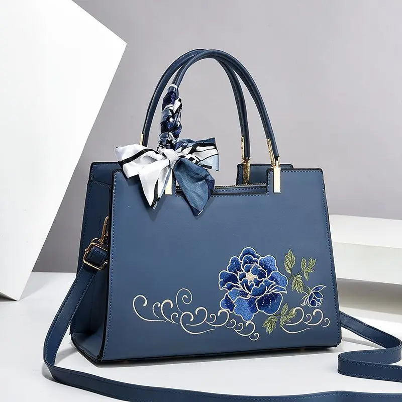 Vegan leather medium size handbag with floral embroidery